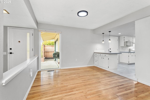 interior space with light hardwood / wood-style flooring and a textured ceiling