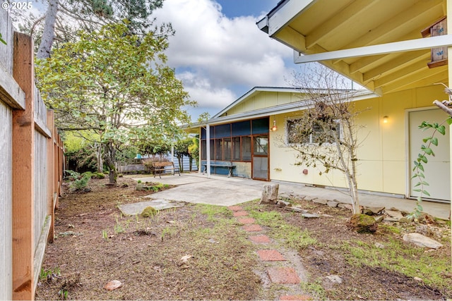 view of yard featuring a patio and a sunroom