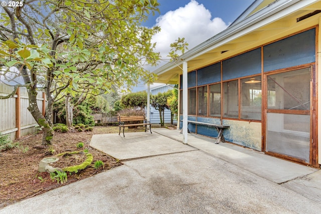 view of patio with a sunroom