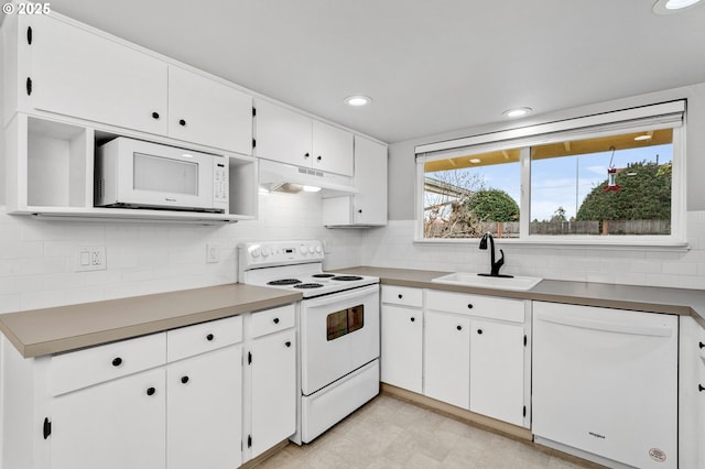 kitchen featuring sink, white appliances, decorative backsplash, and white cabinets