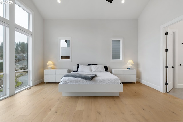 bedroom featuring recessed lighting, baseboards, and light wood-style floors