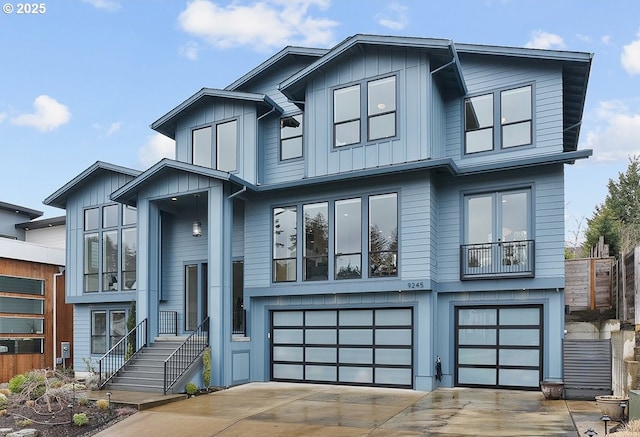 view of front of property with board and batten siding, an attached garage, and driveway