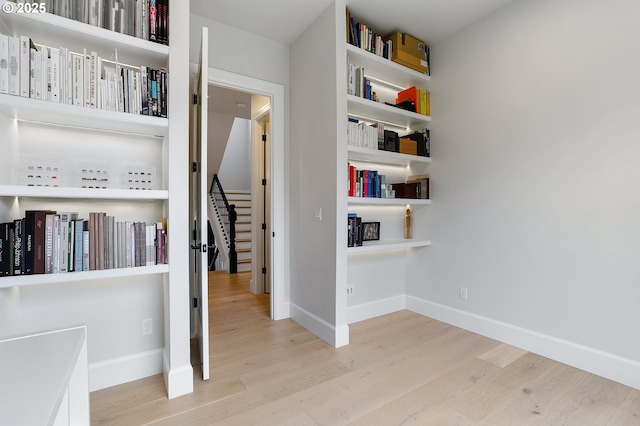 interior space with baseboards and wood finished floors