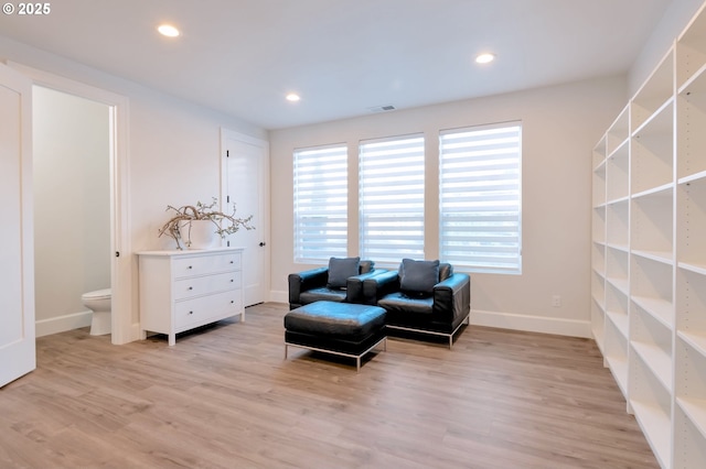 sitting room featuring light wood-type flooring, visible vents, baseboards, and recessed lighting