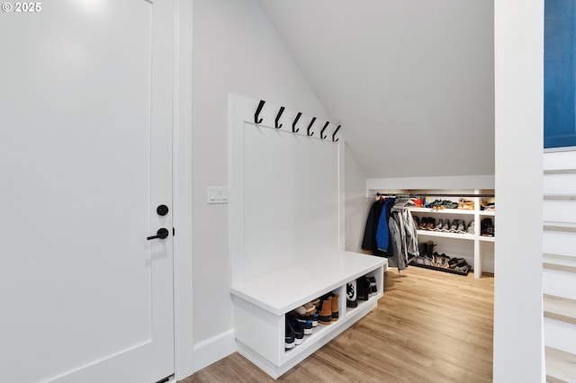 mudroom featuring lofted ceiling and wood finished floors