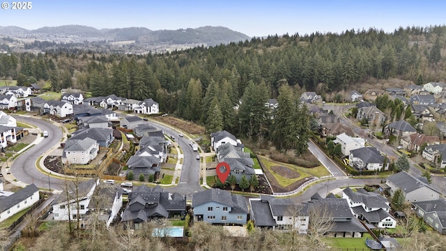 drone / aerial view featuring a forest view and a residential view