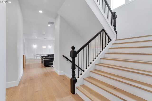 stairs featuring recessed lighting, visible vents, baseboards, and hardwood / wood-style flooring