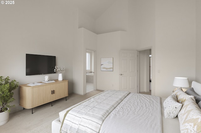 bedroom with light colored carpet, baseboards, and a towering ceiling