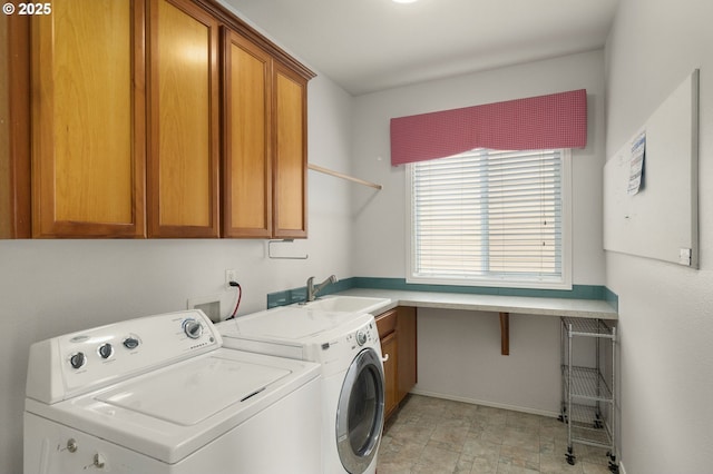 laundry area with a sink, baseboards, washing machine and dryer, and cabinet space