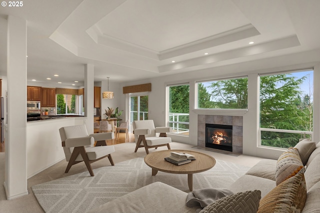 interior space featuring a raised ceiling, a fireplace, and recessed lighting