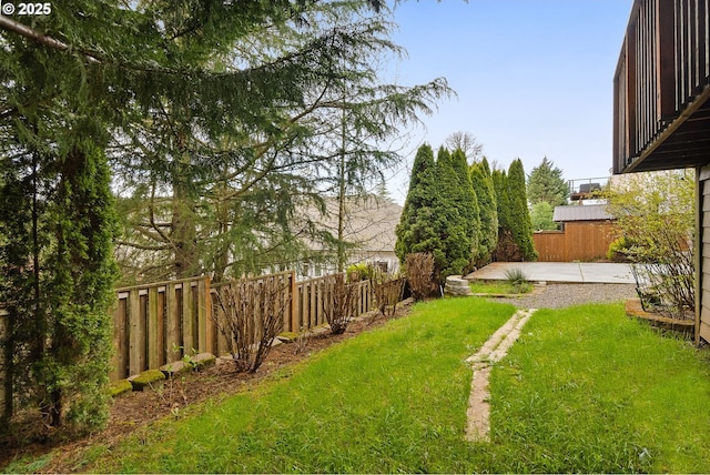 view of yard featuring fence and a patio area