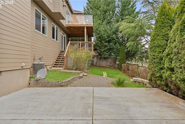view of patio with stairs, a fenced backyard, and central AC unit