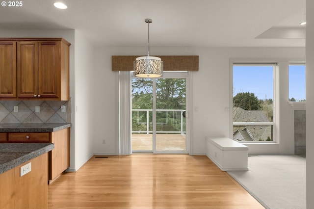 unfurnished dining area with recessed lighting and light wood finished floors