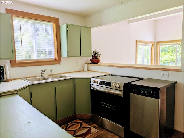 63579 Seven Devils Rd, Coos Bay, OR 97420 - kitchen with green cabinetry, appliances with stainless steel finishes, healthy amount of natural light, and a peninsula