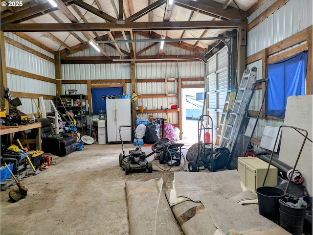 63579 Seven Devils Rd, Coos Bay, OR 97420 - garage featuring freestanding refrigerator and a workshop area