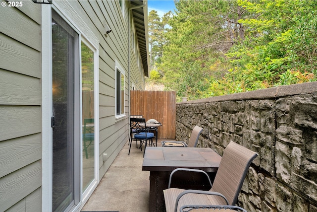 view of patio / terrace featuring outdoor dining space and fence
