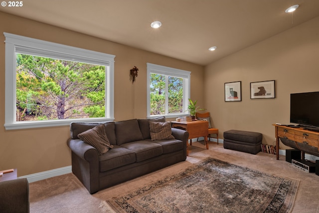 carpeted living area featuring baseboards, recessed lighting, and lofted ceiling