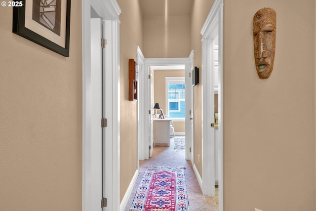 hallway featuring baseboards