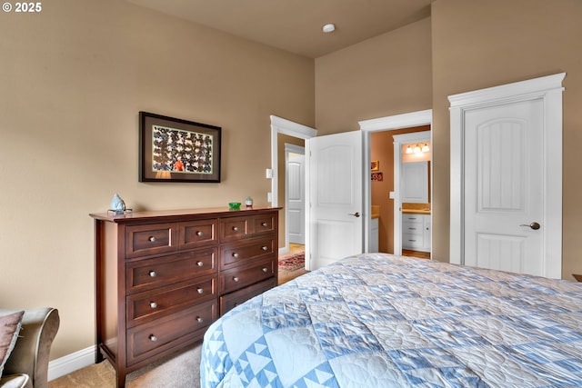 bedroom with baseboards and light carpet
