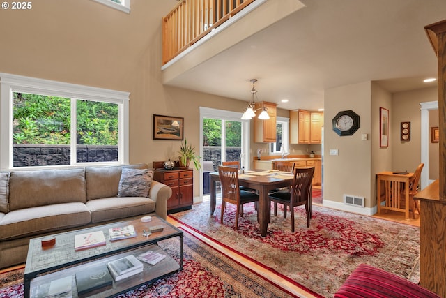 living area featuring baseboards, recessed lighting, and light wood-style floors