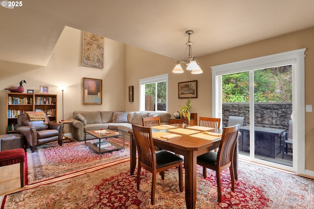 dining area featuring vaulted ceiling