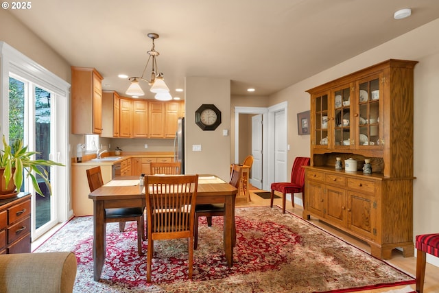 dining room featuring recessed lighting, light wood finished floors, and a chandelier