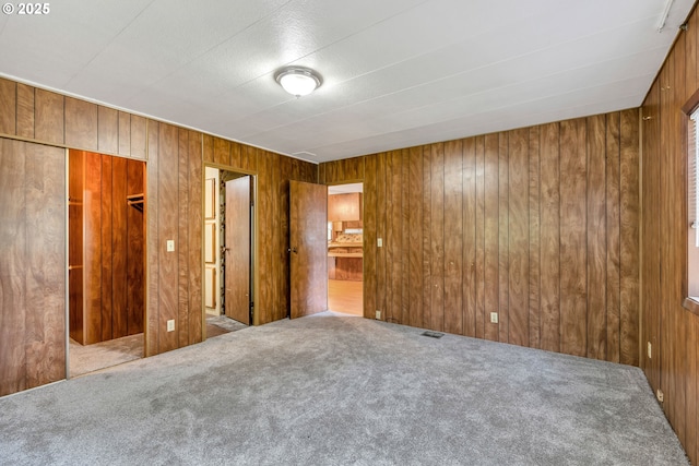 24344 NW Meacham Rd, North Plains, OR 97133 - unfurnished bedroom with carpet, wooden walls, and a closet