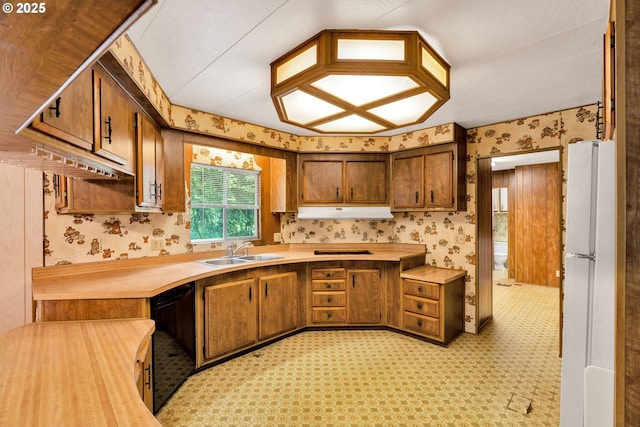 24344 NW Meacham Rd, North Plains, OR 97133 - kitchen with freestanding refrigerator, a sink, black dishwasher, wallpapered walls, and under cabinet range hood