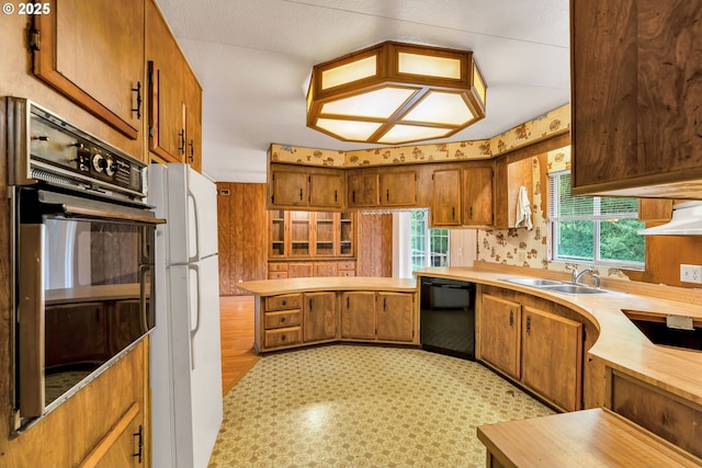 24344 NW Meacham Rd, North Plains, OR 97133 - kitchen featuring black appliances, brown cabinets, a sink, and under cabinet range hood