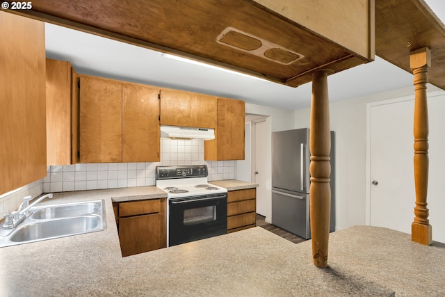 24344 NW Meacham Rd, North Plains, OR 97133 - kitchen with electric range, freestanding refrigerator, a sink, under cabinet range hood, and decorative backsplash