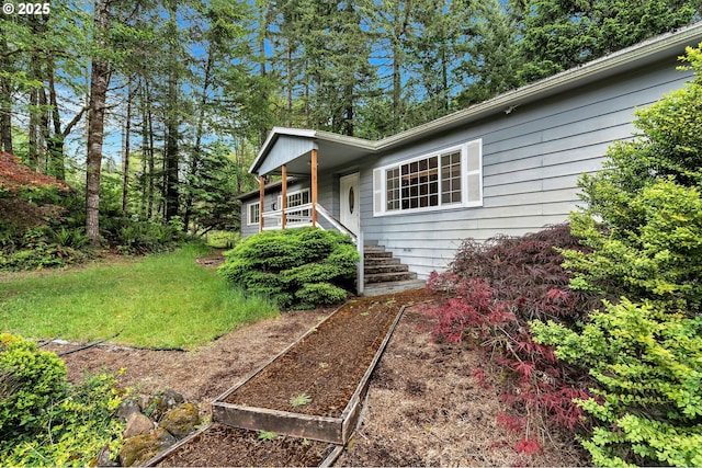 24344 NW Meacham Rd, North Plains, OR 97133 - view of side of property with a porch and a garden