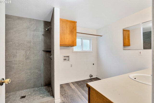24344 NW Meacham Rd, North Plains, OR 97133 - bathroom featuring wood finished floors, a tile shower, vanity, and baseboards