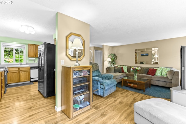 1018 S Holly Ct, Canby, OR 97013 - living room featuring light wood-type flooring and a textured ceiling