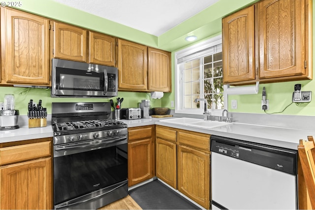 1018 S Holly Ct, Canby, OR 97013 - kitchen featuring appliances with stainless steel finishes, light countertops, and brown cabinetry