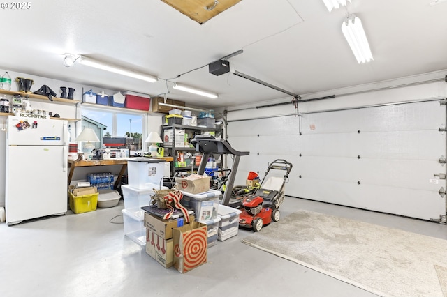 1018 S Holly Ct, Canby, OR 97013 - garage featuring freestanding refrigerator and a garage door opener