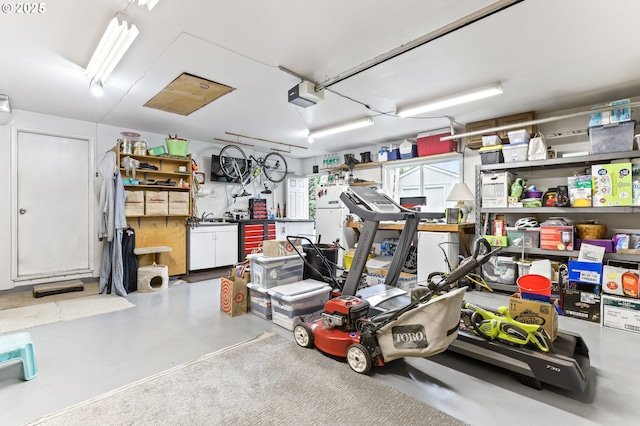 1018 S Holly Ct, Canby, OR 97013 - garage featuring a garage door opener and a sink