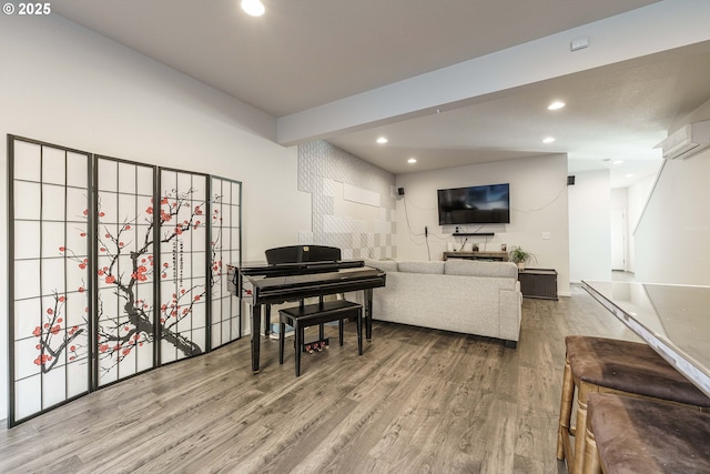 living room with hardwood / wood-style flooring and a wall mounted air conditioner