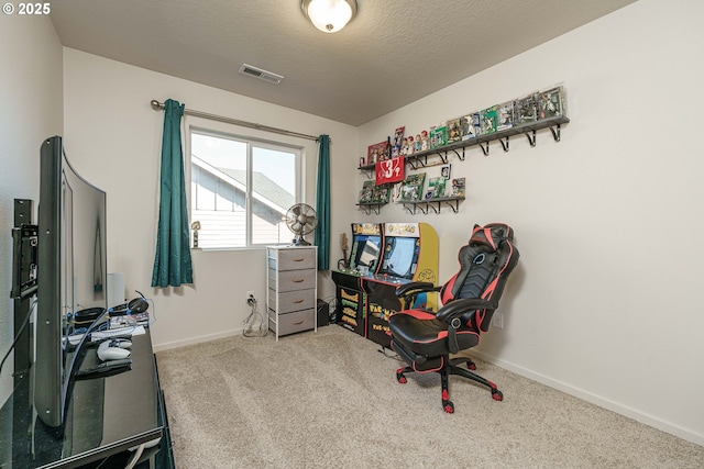 home office featuring a textured ceiling and carpet flooring