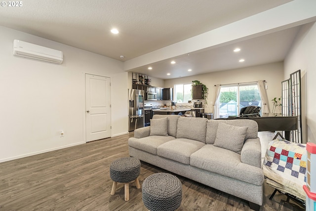 living room with dark hardwood / wood-style floors and a wall unit AC