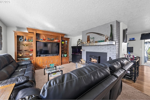 35363 Woodland Ln, Astoria, OR 97103 - living area featuring a textured ceiling, wood finished floors, and a fireplace