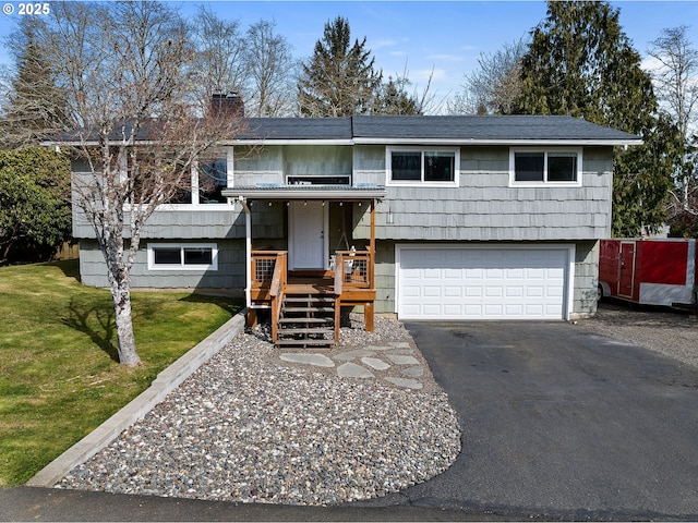 35363 Woodland Ln, Astoria, OR 97103 - raised ranch with an attached garage, driveway, a chimney, and a front lawn