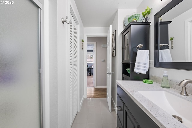 35363 Woodland Ln, Astoria, OR 97103 - bathroom with tile patterned floors, vanity, and baseboards