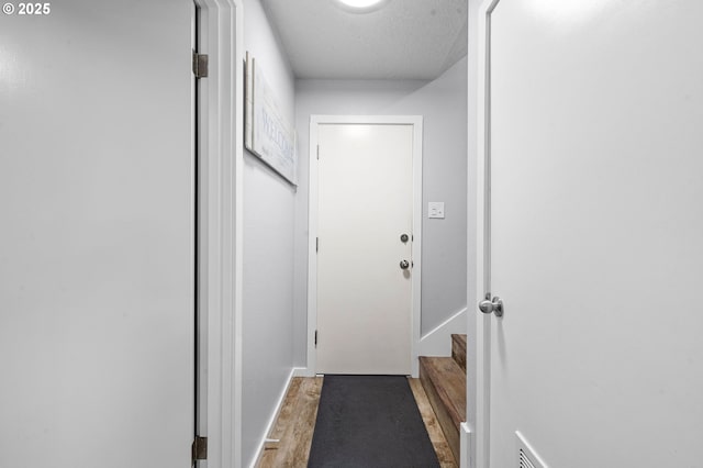 35363 Woodland Ln, Astoria, OR 97103 - doorway to outside featuring baseboards, wood finished floors, and stairs