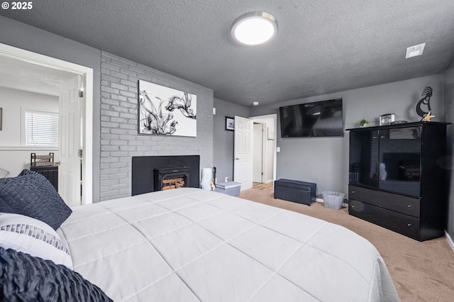 35363 Woodland Ln, Astoria, OR 97103 - bedroom with carpet flooring, a fireplace, and a textured ceiling