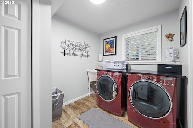 35363 Woodland Ln, Astoria, OR 97103 - laundry room with washer and dryer, laundry area, wood finished floors, and baseboards
