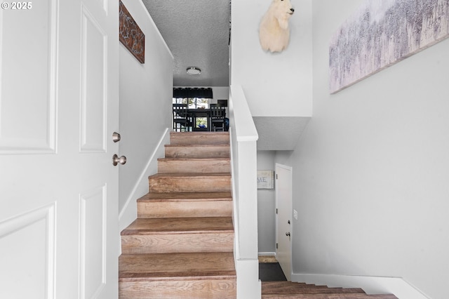 35363 Woodland Ln, Astoria, OR 97103 - stairs with baseboards and a textured ceiling