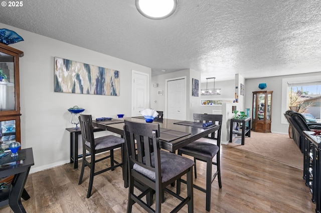 35363 Woodland Ln, Astoria, OR 97103 - dining space featuring baseboards, wood finished floors, and a textured ceiling
