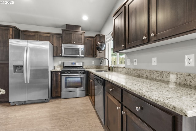 2474 Equestrian Loop S, Salem, OR 97302 - kitchen with appliances with stainless steel finishes, dark brown cabinetry, light wood finished floors, light stone countertops, and recessed lighting