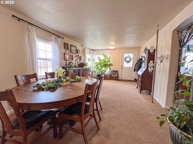 dining area with carpet flooring and a textured ceiling