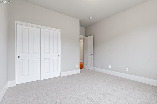 unfurnished bedroom with carpet floors and a closet